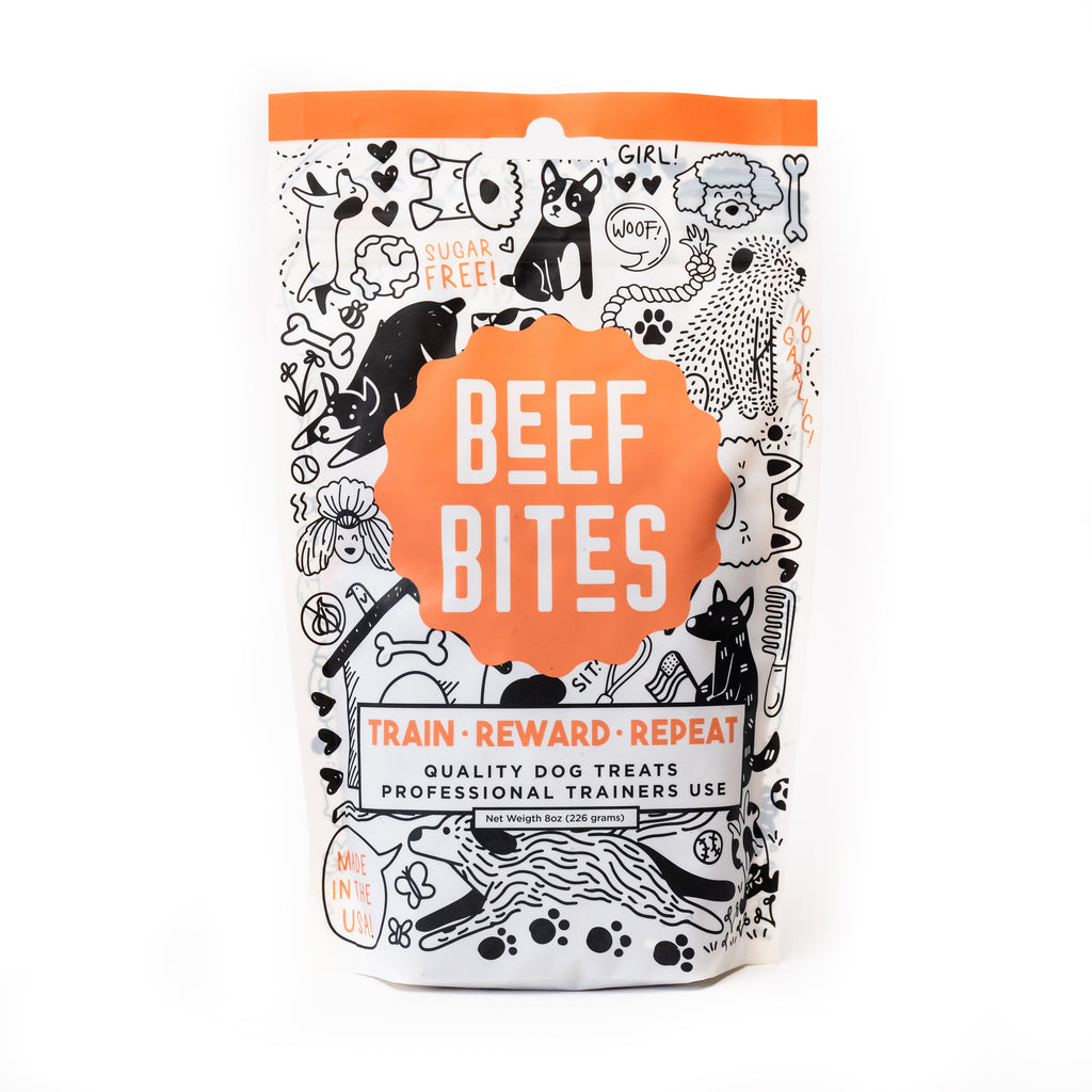 Front view of HoodHound Beef Bites dog treat packaging – orange and black illustrated bag with text "Train, Reward, Repeat"