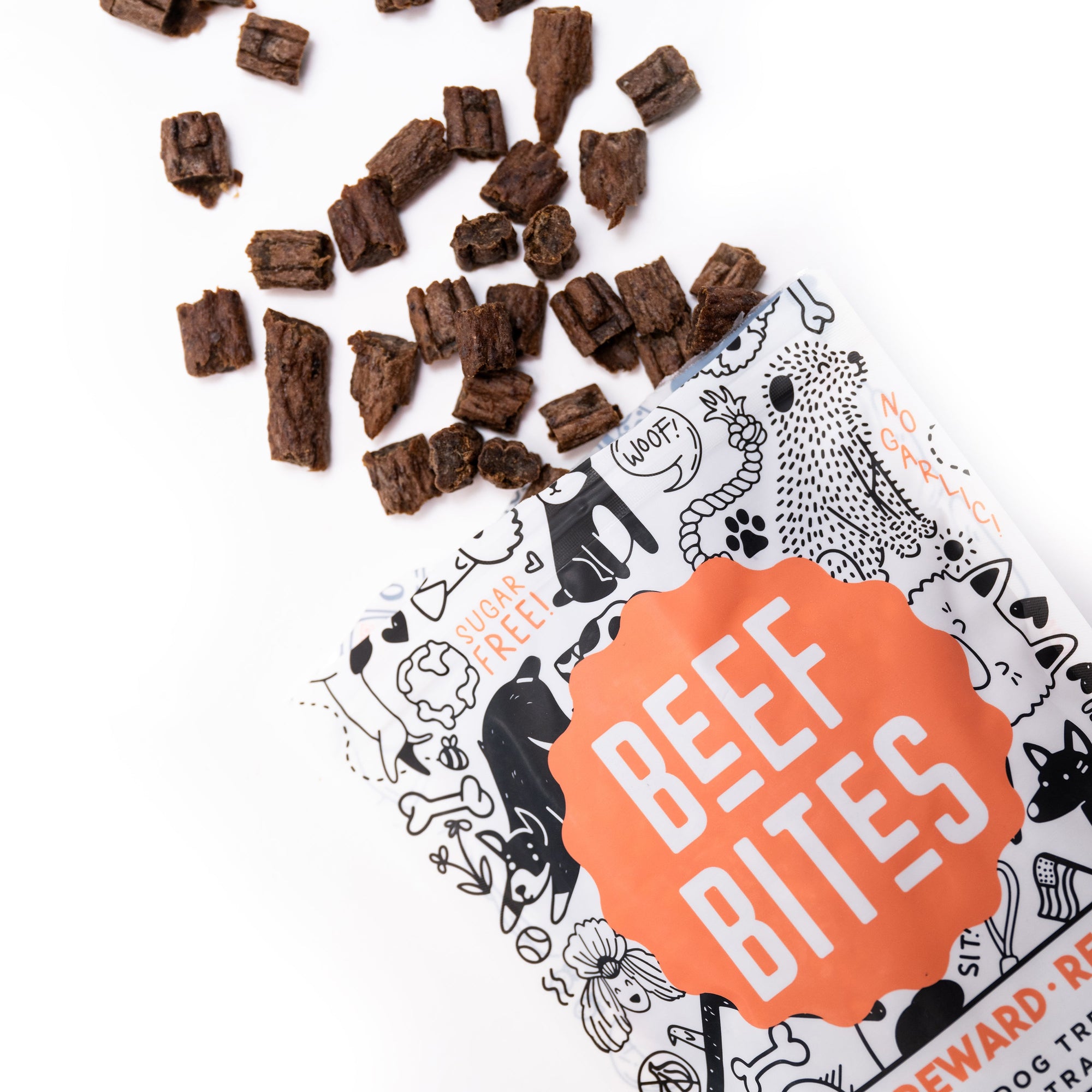 Overhead view of HoodHound Beef Bites dog treats poured from bag - healthy, high-value rewards for positive reinforcement training